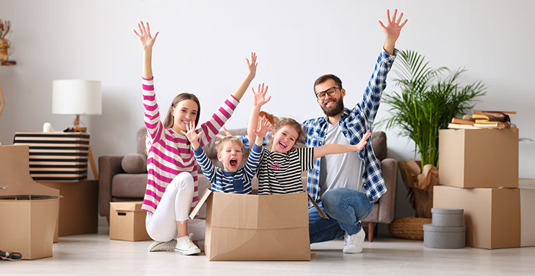 Family cebelrating unpacking boxes in their new rental